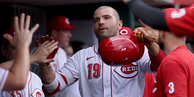 Joey Votto #19 of the Cincinnati Reds celebrates with teammates after hitting a home run in the second inning against the Chicago Cubs at Great American Ball Park on May 25, 2022 in Cincinnati, Ohio. 