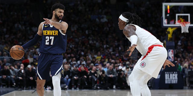 Jamal Murray (27) of the Denver Nuggets brings the ball down the court against Terance Mann (14) of the Los Angeles Clippers in the second quarter at Ball Arena Feb. 26, 2023, in Denver, Colo. 