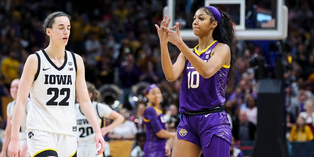 Apr 2, 2023; Dallas, TX, USA; LSU Lady Tigers forward Angel Reese (10) gestures towards Iowa Hawkeyes guard Caitlin Clark (22) after the final round of the Women's Final Four NCAA tournament at the American Airlines Center.