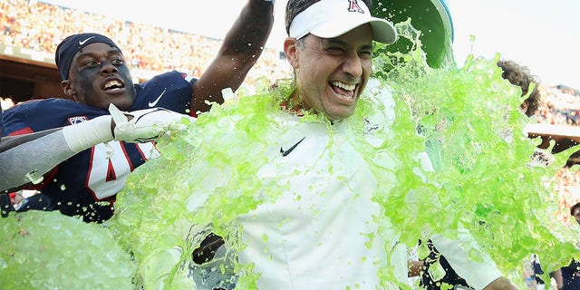 Jedd Fisch celebrates after beating ASU