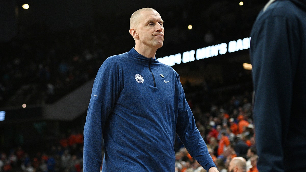 Mark Pope reacts after a basketball game